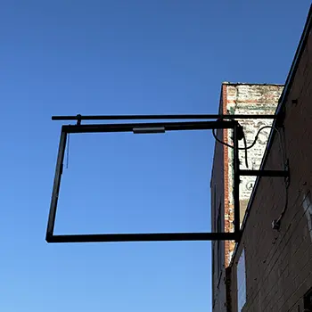 blank city sign against blue sky